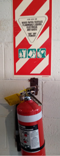 A fire extinguisher on a wall

Description automatically generated