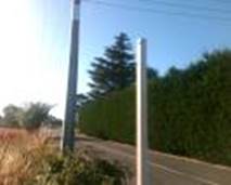 A pole next to a road

Description automatically generated