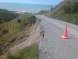 A road with a cone on the side

Description automatically generated