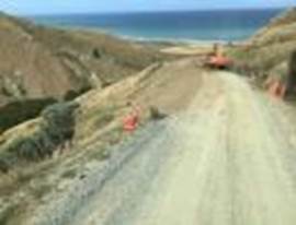 A dirt road with orange cones on it

Description automatically generated