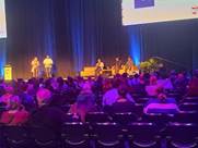 A group of people on a stage

Description automatically generated