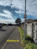 A street with a sign on it

Description automatically generated