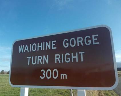 A brown sign with white text

Description automatically generated