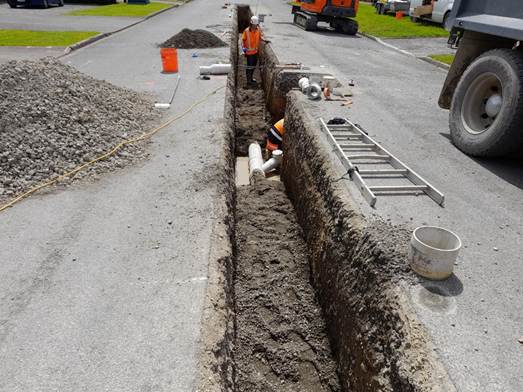 A construction workers working on a road

Description automatically generated