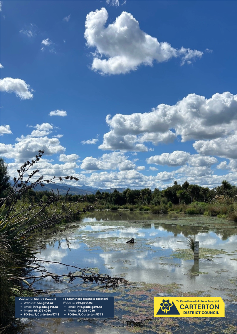 A pond with trees and clouds in the sky

AI-generated content may be incorrect.