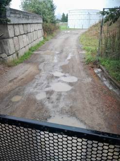 A dirt road with puddles on it

AI-generated content may be incorrect.