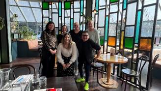 A group of people posing for a photo

AI-generated content may be incorrect.