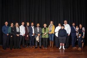 A group of people standing together

AI-generated content may be incorrect.