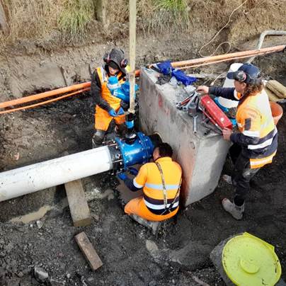 A group of men working on a pipe
AI-generated content may be incorrect.