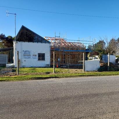 A building under construction by a road
AI-generated content may be incorrect.