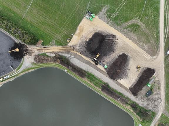 Aerial view of a pond and land
AI-generated content may be incorrect.