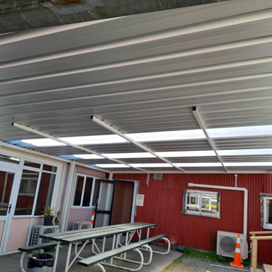 A picnic table and benches under a roof
AI-generated content may be incorrect.